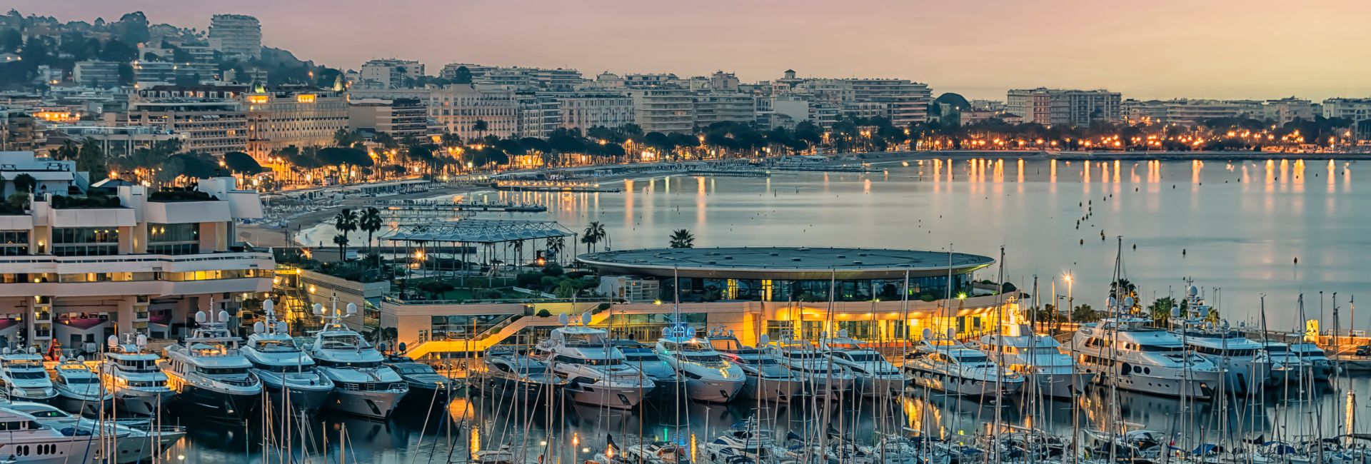Panoramic night view of Cannes with the port and illuminated city — Cannes Film Festival 2026 private chauffeur